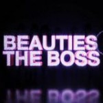 A neon sign with the words 'Beauties The Boss' on a black background