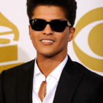 Bruno Mars, Quinceanera man in a suit and sunglasses posing for a picture