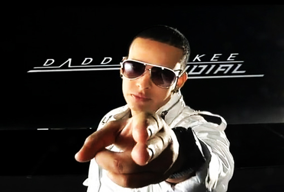 Daddy Yankee, a man in a white shirt and sunglasses pointing at the camera at a Quinceanera celebration