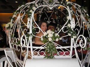 A Quinceanera ceremony with a bride and groom in a white horse-drawn carriage