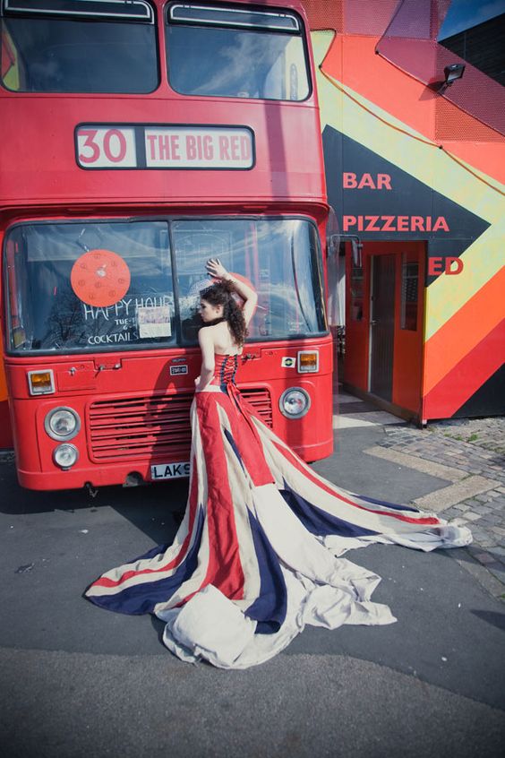 Quinceañera posing in front of a red double decker bus