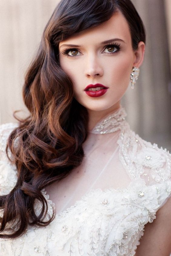 A woman wearing a purple and white quinceanera dress with a red lips makeup look