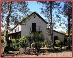 Quinceanera at Andres Pico Adobe Park, a large white house surrounded by trees and bushes