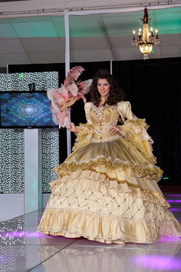 Fashion model Quinceañera dresses, a woman in a yellow dress on a runway