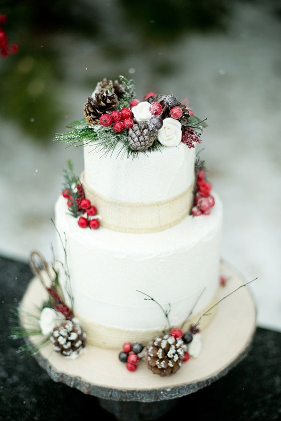 Quinceanera cake, a three tiered cake decorated with pine cones and berries