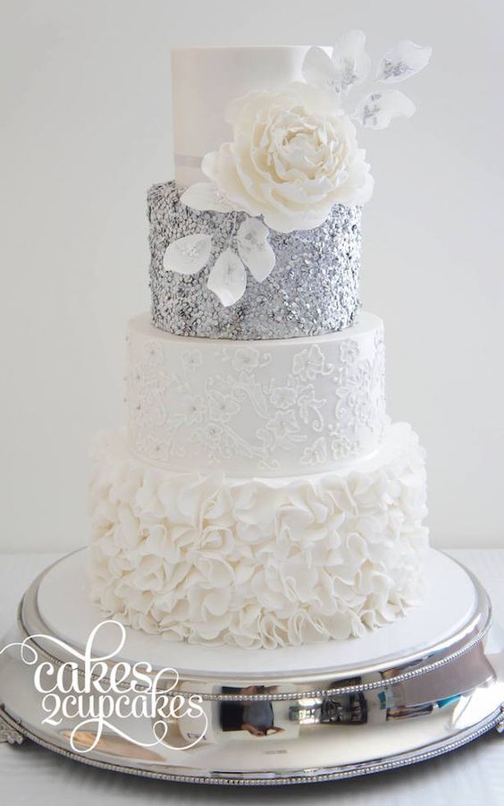 Quinceanera cake ideas, a glamorous white and silver three tiered cake with white flowers