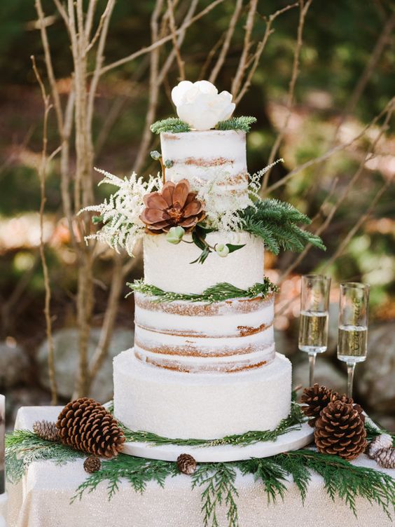 A Quinceanera cake, with pine cones and greenery