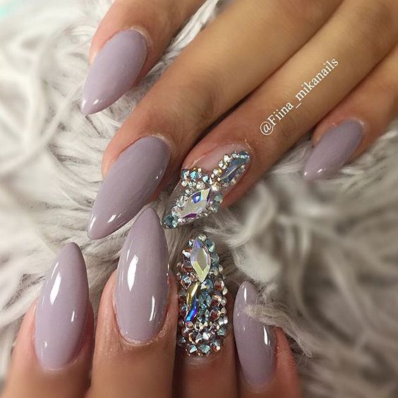 A woman's hand with a purple manicure and a ring on it, perfect for a Quinceanera