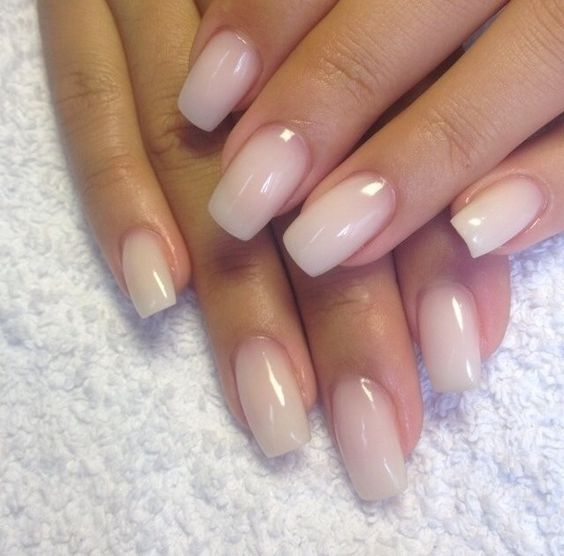 A woman's hand with a pink and white manicure, featuring Eveline 8 Em 1 Total Action