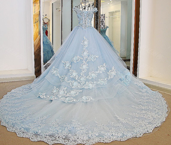 Quinceanera dresses princess ball gown in light blue, a dress on display in front of a mirror