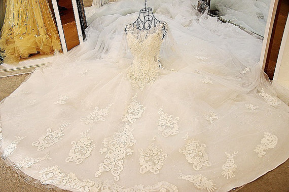 A Quinceanera gown is displayed in front of a mirror