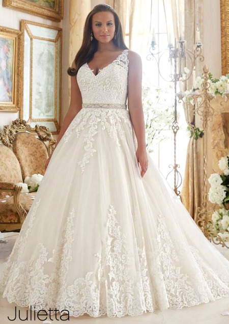 Morilee, a woman in a Quinceanera dress standing in front of a couch