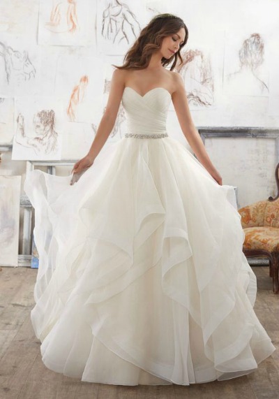 Quinceanera dress, a woman in a Quinceanera dress standing in a room
