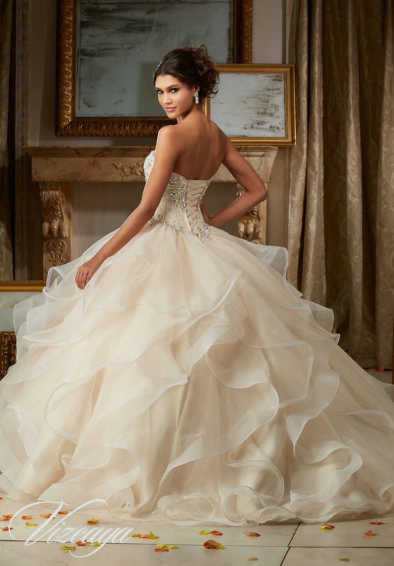 A woman in a Quinceanera gown posing for a picture