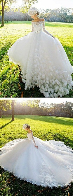 A woman in a Quinceanera gown sitting in the grass