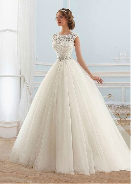 A woman in a quinceanera dress standing in a room