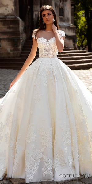 A woman in a Quinceanera gown standing on steps