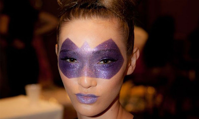 Model Shelbi Byrnes sports a masquerade makeup look for Moda 2000.