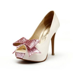Quinceanera Shoe, a pair of white high heels with a pink bow