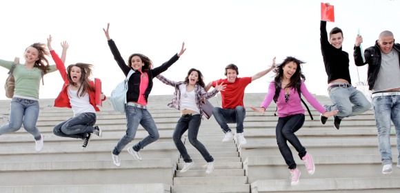 Cheerful students jumping.