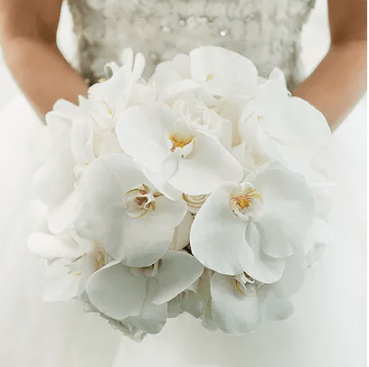 A Quinceanera holding a bouquet of white orchid flowers