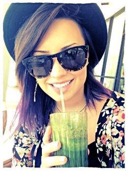 Beautiful Demi Lovato drinking vegetable smoothie.