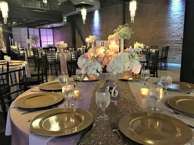 A table set for a formal Quinceanera dinner at a banquet hall