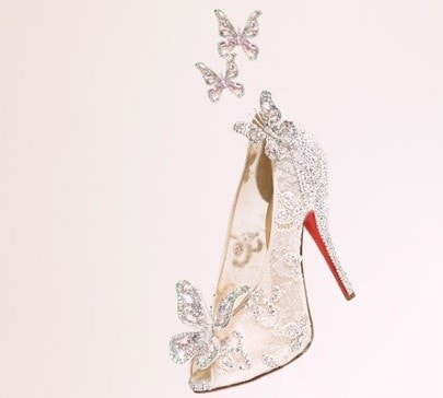 A pair of high heeled shoes with butterflies flying out of them, inspired by Cinderella and Christian Louboutin, perfect for a Quinceañera