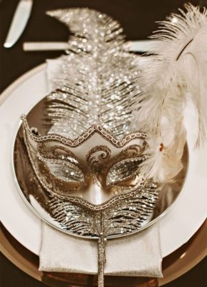 Quinceanera image: A beautiful plate featuring a mask and feathers, representing party and grad ball themes.