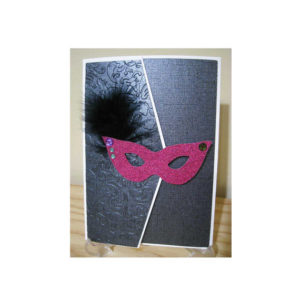 A picture frame with a pink mask on it from a Quinceanera masquerade ball.