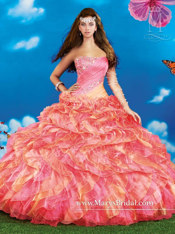 A woman wearing a pink gown standing in a field