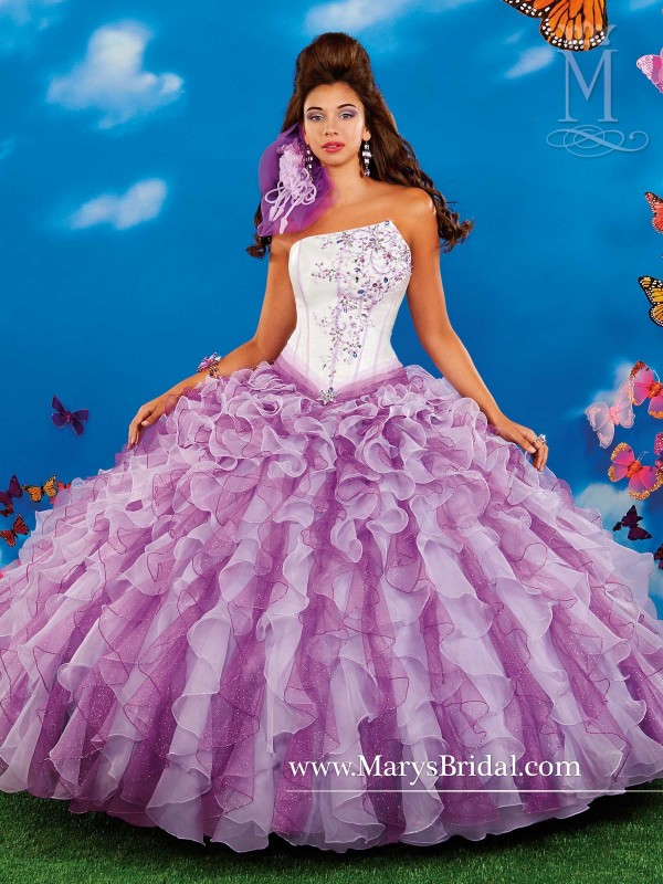 A woman in a purple dress posing for a picture, wearing a Quinceanera gown