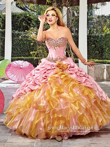 A woman in a Quinceanera gown dress, holding an umbrella, wearing a pink and gold dress