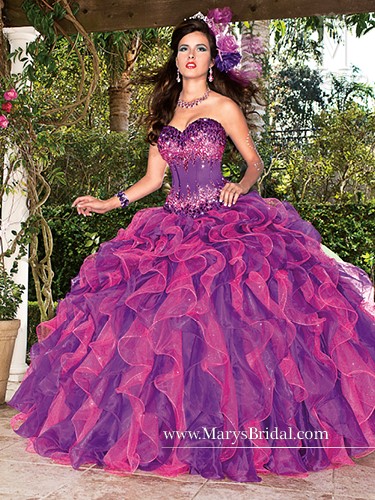 Quinceanera gown, a woman in a purple dress posing for a picture
