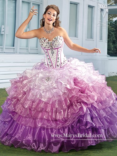 A woman posing for a picture in a purple and white Quinceanera ball gown