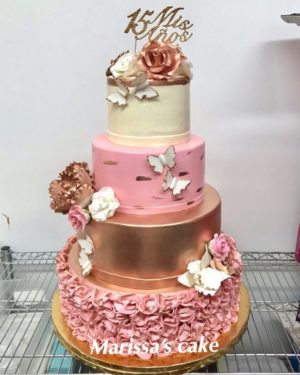 Quinceanera cake, a three tiered cake with flowers and butterflies