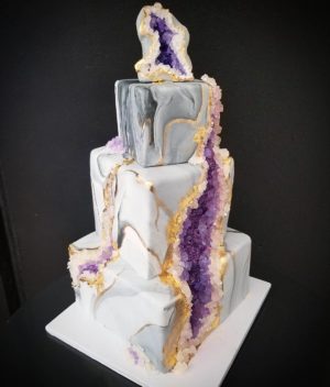 Quinceanera cake, a three tiered cake with purple and white icing