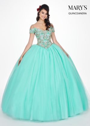 A woman in a ball gown posing for a picture wearing tiffany blue Quinceañera dress