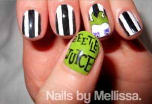 Quinceanera inspired manicure with a Beetlejuice face design, featuring a green and black nail art