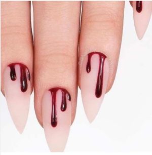 Quinceanera-themed nail designs featuring a woman's nails with blood dripping on them