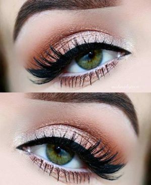 A close up of a person's eye with a pair of lashes, showcasing a beautiful Quinceanera makeup look with eyeshadow