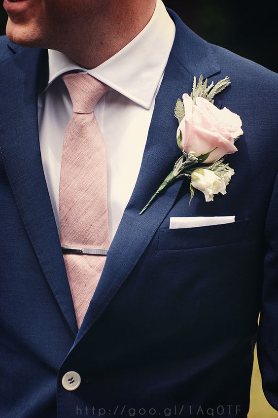 A navy blue with blush pink Quinceanera invitation featuring a close up of a person wearing a suit and tie