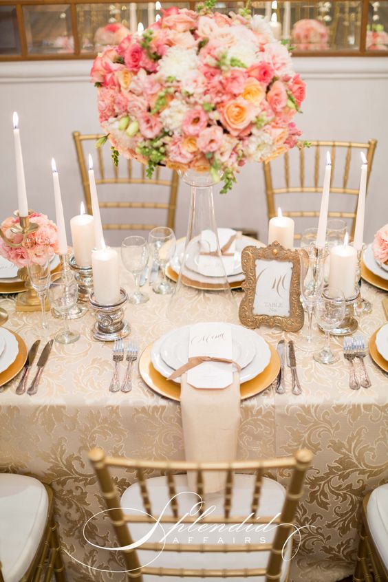 Quinceanera decorations: a table set for a formal dinner with coral-themed candles and flowers