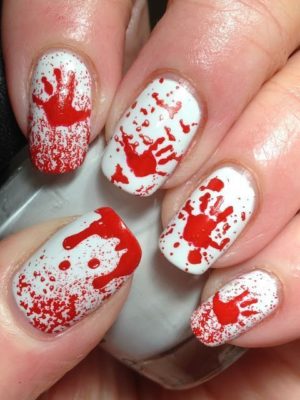 A spooky Quinceanera nail art design, featuring a white and red manicure