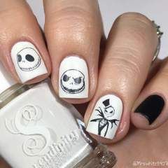 Quinceanera-themed nail decals with a black and white design, held by a person