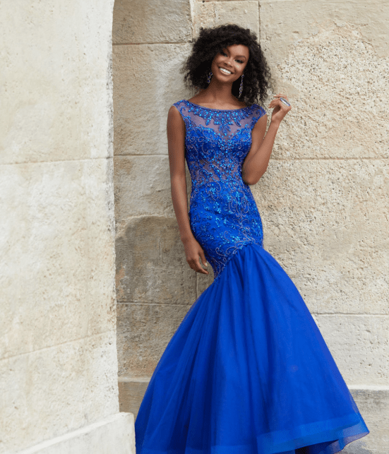 A woman in a blue Quinceanera gown posing for a picture