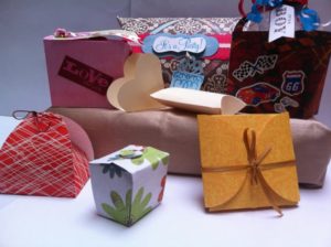 A table topped with lots of different types of boxes for Quinceanera product design