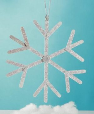 Quinceanera theme image: A popsicle stick snowflake ornament hanging from a string