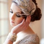 A woman in a silver dress with a headband, showcasing a 1920s inspired Quinceanera hairstyle