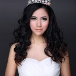 A beautiful young woman wearing a round crown hairstyle and a tiara, looking radiant